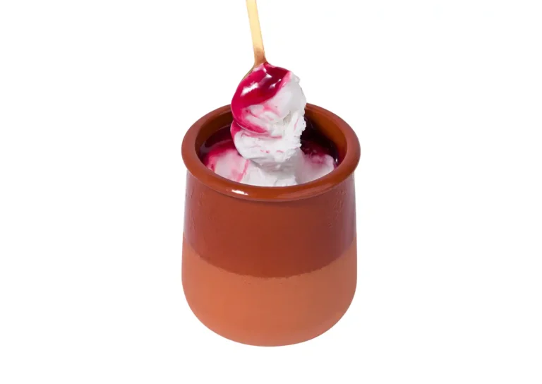 Yogurt ice cream with cherry sauce